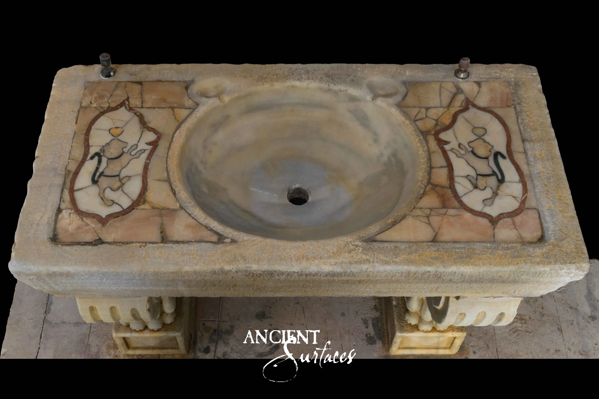 Antique limestone sink by Ancient Surfaces with a hand cut marble mosaic top and a worn oval basin, photographed from above